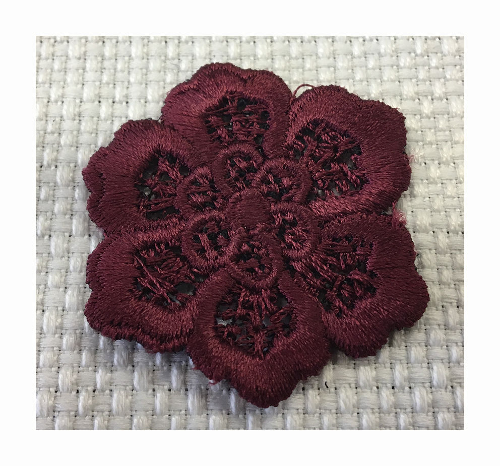 Embroidered macramè effect flower made with a contour cutting technique plus a 3D effect
