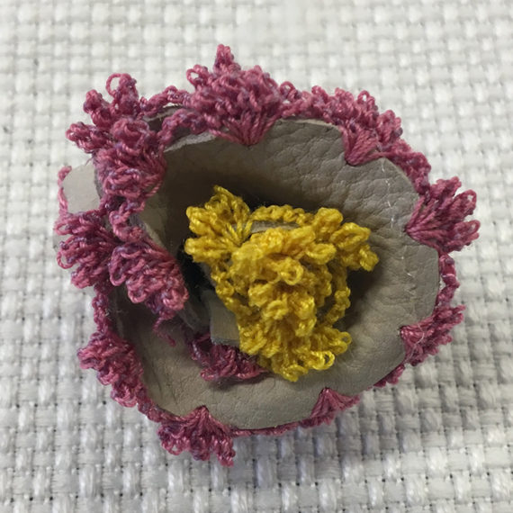 Flower made with two different materials : leather and thread