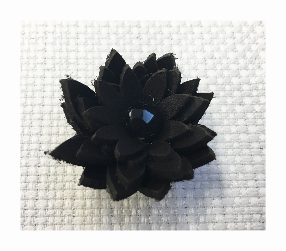 Multilayer flower made with cut leather with a central half crystal