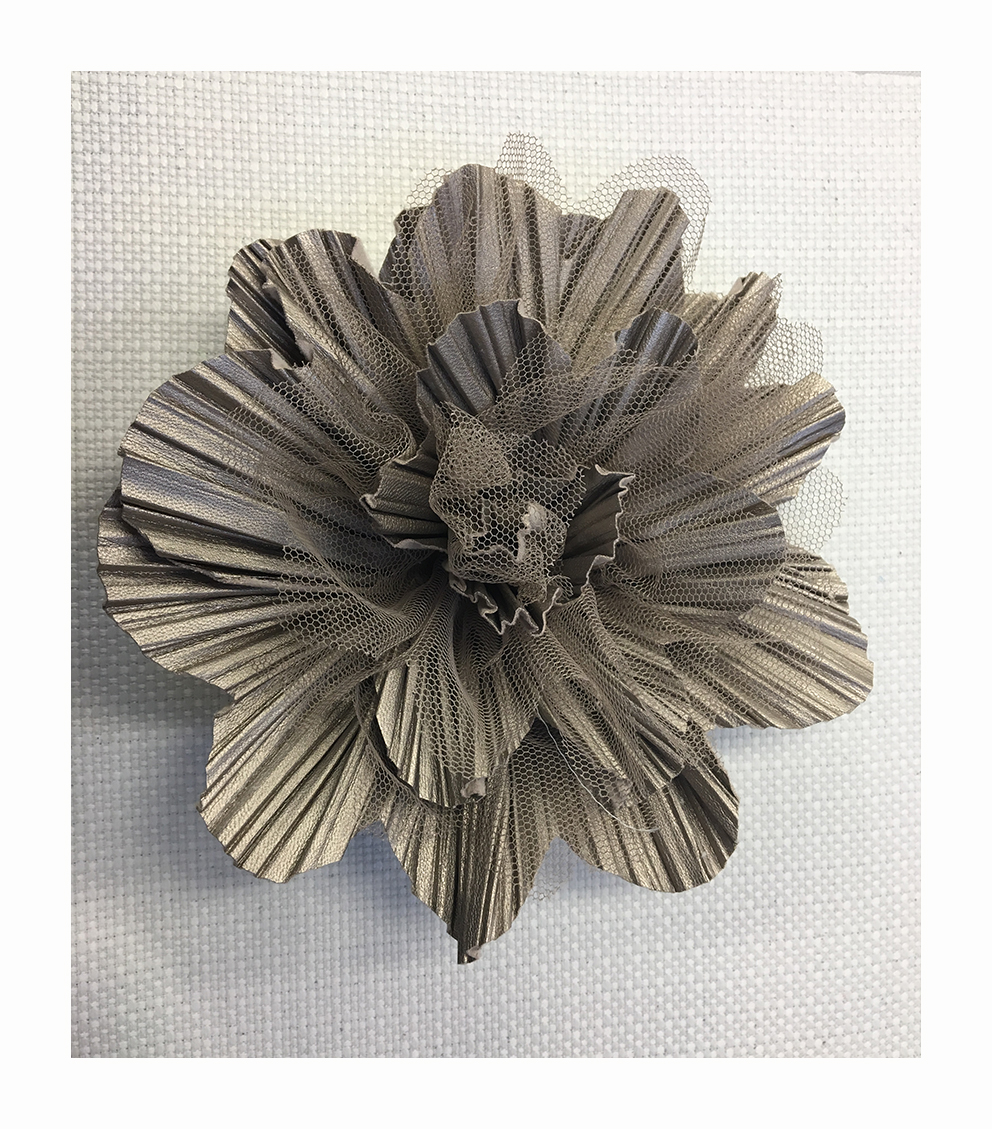 Flower made with mixed techniques : cut and pleated leather with tulle laser treated petals.