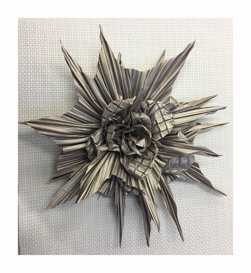 Maxi flower made in two different types of pleated leather and petals cut